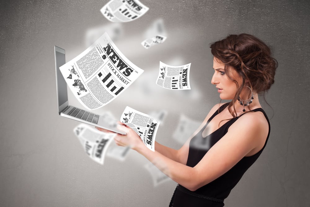 Casual pretty young woman holdin notebook and reading the explosive news Casual pretty young woman holdin notebook and reading the explosive news